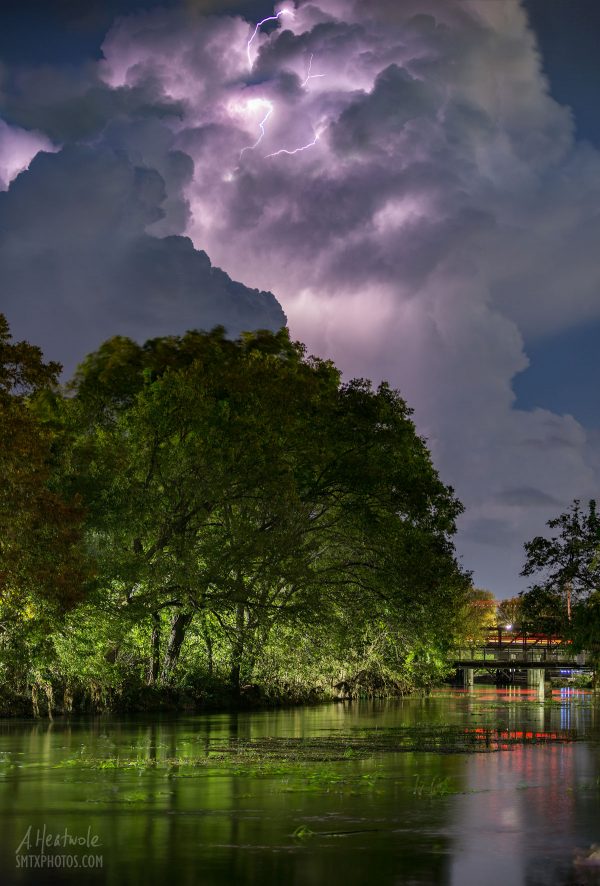 Lightning flashing from a massive thunderhead over the San Marcos River.