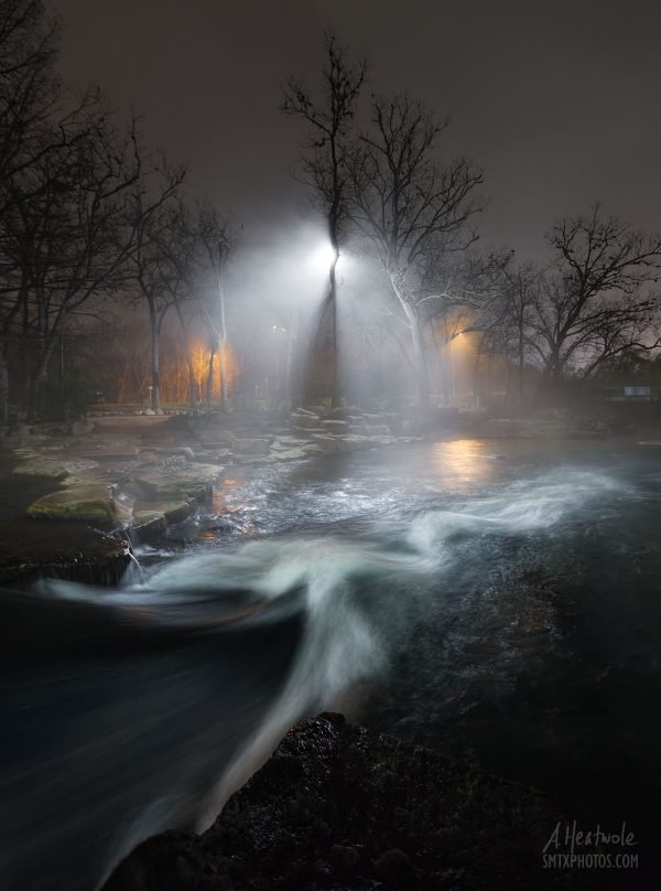 Lights shine through the fog on the San Marcos River at Rio Vista.