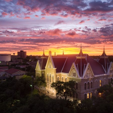 Old Main glows in the sunset on the Texas State University Campus.