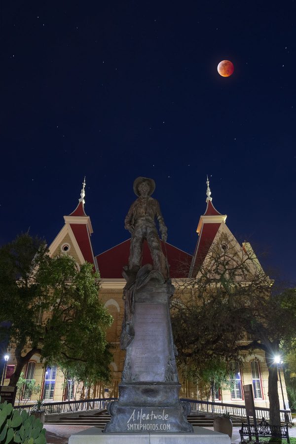 The blood moon glows red above Old Main at Texas State University.